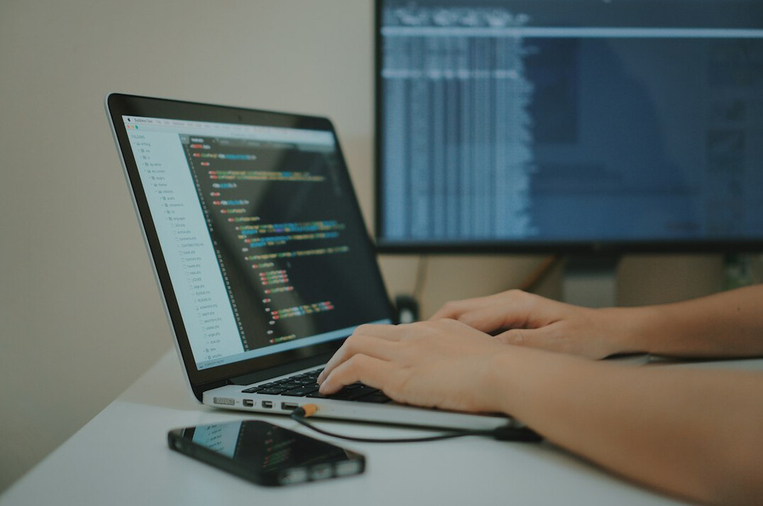 programmer at desk with insurance code
